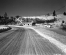 Curve in Snow Covered Road with Dwelling and Trailer