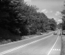 Cars Parked by Paved Road