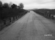 Hilly Road in Castleton with River and Bridge