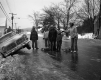 Group of Sledders Next to Crashed Car
