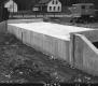 Concrete Culvert over Downs Brook in Middlesex, with Dwellings in The Background