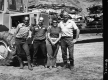 Car Crushing Site In Richmond, People Posing in Front of Machinery