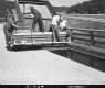 US Route 2 Paving in Middlesex, Men Applying Chip Seal