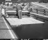 US Route 2 Paving in Middlesex, Men Applying Chip Seal on Bridge Section Over Railroad