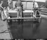 US Route 2 Paving in Middlesex, Men Applying Chip Seal on Bridge Section 2