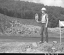 Sandy Wood, Flag Person at Construction Site in Barnet, Piles of Rubble and Debris in the Background 2