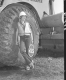 Sandy Wood, Flag Person at Construction Site in Barnet, Leaning Against Tire of Construction Vehicle