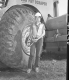 Sandy Wood, Flag Person at Construction Site in Barnet, Leaning Against Tire of Construction Vehicle 2