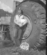 Sandy Wood, Flag Person at Construction Site in Barnet, Leaning Against Tire of Construction Vehicle 3