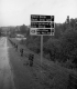 Sign by Paved Road