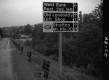 Sign by Paved Road