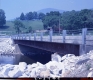 Completed Bridge Construction Over Small River With Dwelling  (Color)
