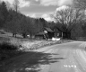 Curve in Unpaved Road with Dwellings and Barn in Plymouth