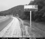 Sign by Paved Road