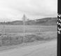 Sign by Paved Road