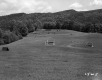 Grassy field with equestrian jumping fences