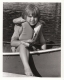 A young child sitting in a canoe