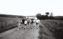 A group of runners on a dirt road
