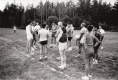 A group of runners gathered in a field