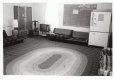 A common space with couches and a fridge
