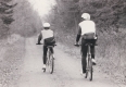 . Man and Woman Riding on Dirt Track