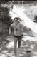 A smiling woman runs along a dirt road