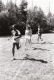 Four people run through a field