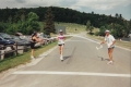 A woman runs toward a finish ribbon in front of the Willoughby Beach