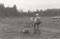 Bicyclist attempting to ride over oil can