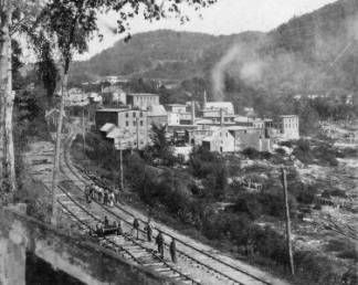 Steam Powered Factory Along Railroad
